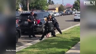 Police officers stop fellow officer punching handcuffed woman during arrest [upl. by Farah933]